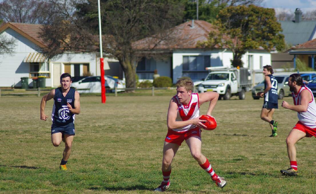 TOUGH: Goulburn Swans player Sam Buchanan makes a run for it as fellow player Jimmy Condylios supports him from the right. Cootamundra player Dylan McDermott (left) is on  the chase. Goulburn is now into the Grand Final to be played on September 5 in Gungahlin. (Photo by Darryl Fernance) 