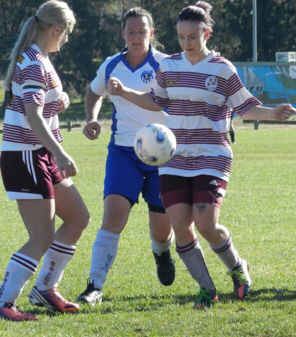 COMBINING: Strikers Maddi Thorne and Maddy Cranston combine to beat a Majura opponent.