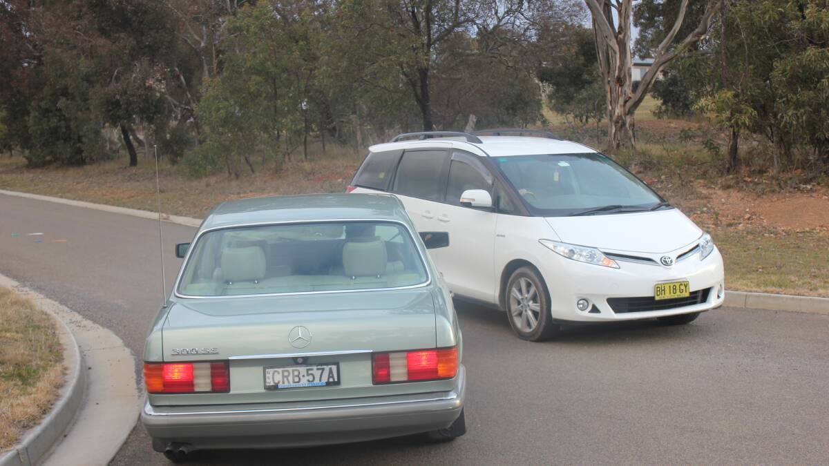 TIGHT FIT: Carr St residents Eric Day and Sharon Howe demonstrated to the Goulburn Post how narrow the entrance to the street really is by passing each other in their cars. According to their measurements, the road width, minus the kerbs, is only 5.1 metres.