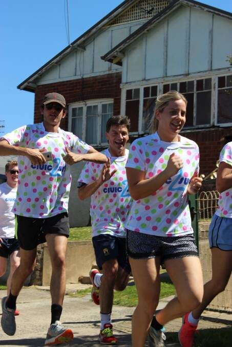 IN STRIDE: Federal Member for Hume Angus Taylor accompanies ANU students on
their Civic2Surf charity relay leg into Goulburn on Friday.