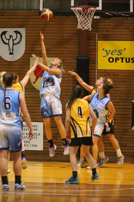 SHOOTING: Goulburn Bears No. 10 Naomi Lucas puts a shot up closely guarded by the Tigers as Courtney Edwards No. 13 looks for a rebound opportunity. Photo: Robert Crawford. 