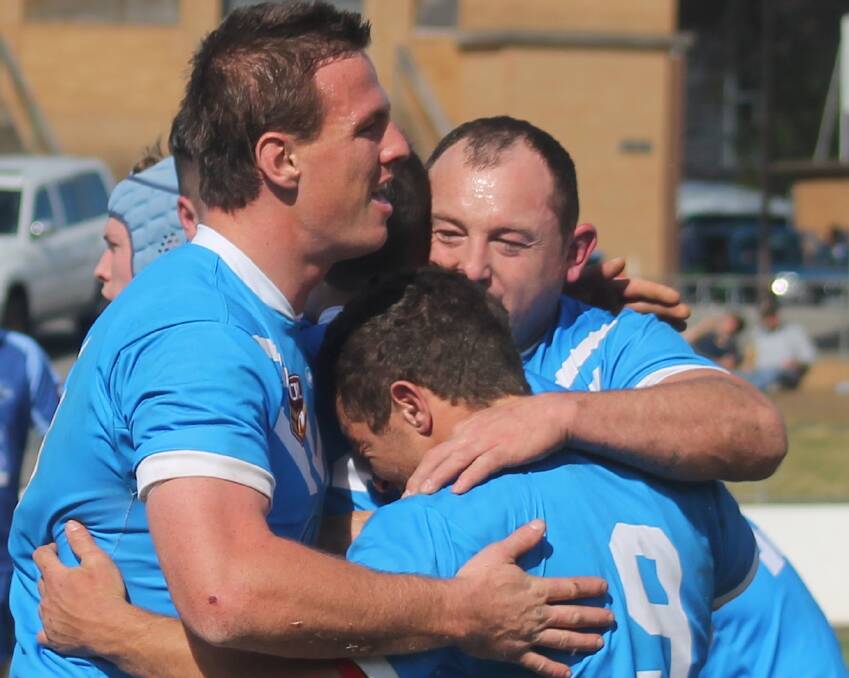 Queanbeyan Blues' reserves players celebrate a try during their 22-14 come-from-behind grand final win over the West Belconnen Warriors last Sunday. Photo: Miles Thompson.