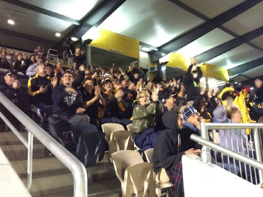Queanbeyan Tigers fans celebrate as their Rising Stars side claimed an 8.8.56 to 5.8.38 premiership win over Ainslie in Gungahlin on Saturday night. Photo: Queanbeyan Tigers.