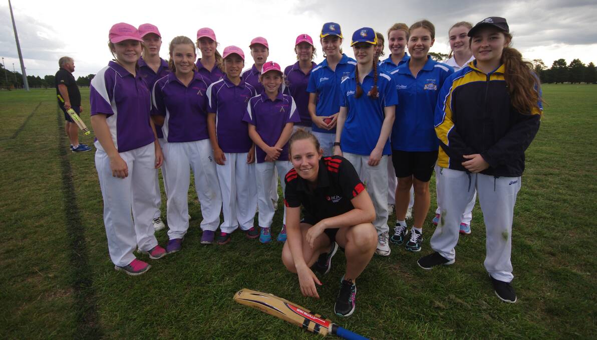 Sydney Thunder and Canberra Meteors cricketer Sam Bates with the girls from Goulburn's Cowgirls cricket team and their ANU opponents before the game on Carr Confoy Park on Friday, February 12. Photo by Darryl Fernance.
