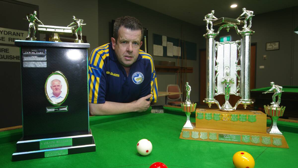 CHAMPION AGAIN: Graham Taylor the newest life member of the Goulburn Snooker and Billiards Association with the perpetual championship trophies for both disciplines, he won this year. Photo by Darryl Fernance.

