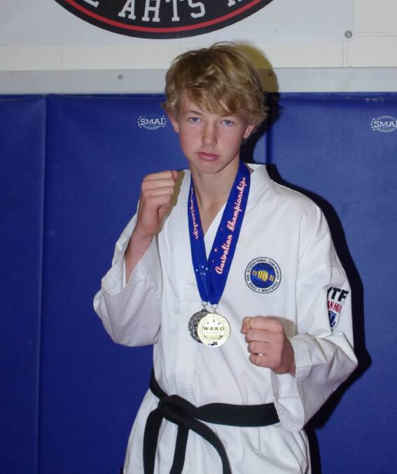 CHAMPION: Ben Robertson proudly displays his medals from the World Association of Kickboxing Organisation National Championships. Photo: Darryl Fernance.
