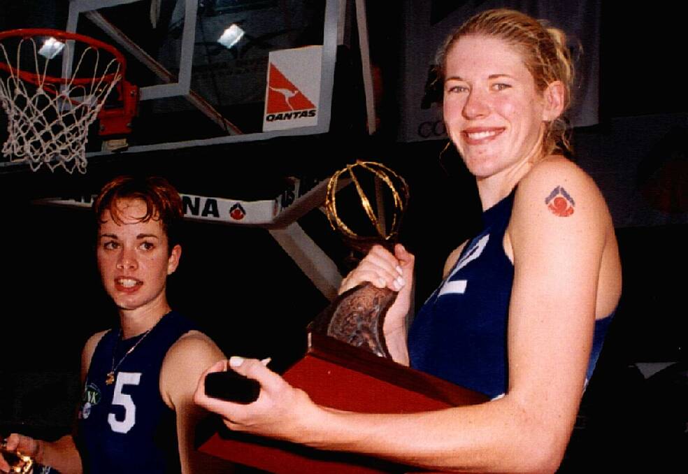 Before Lauren Jackson turned 18, she had already led AIS to the 1998/99 championship along with a Most Valuable Player award and Rookie of the Year. Pictured here with teammate Kristen Veal (left) holding 1998/99 championship trophy after that monumental game, where for the first time in WNBL history the championship was won by a Canberra team, the youngest by average age in the history of the competition, to win. Photo by Darryl Fernance.
