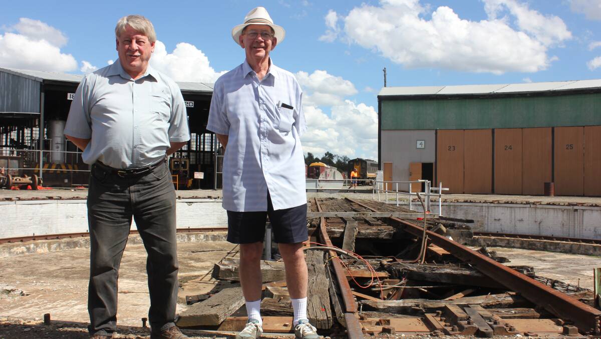FRUSTRATED: Goulburn Loco Roundhouse Preservation Society (GLRPS) volunteers John Proctor and Terence Carpenter inspect the damage to the turntable, which has still not been repaired after a derailment there nine months ago.
