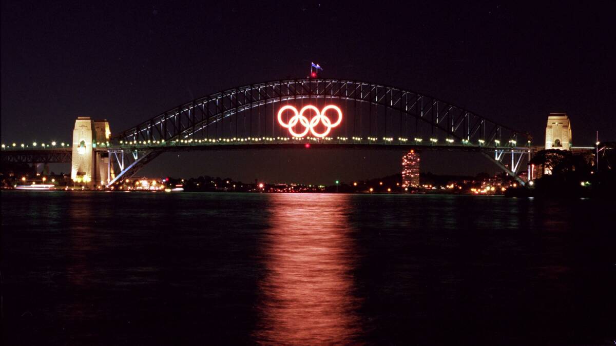 LIT UP: The Olympic Rings shining above Sydney Harbour during the 2000 Games. Photo: Adam Petty, Getty Images.