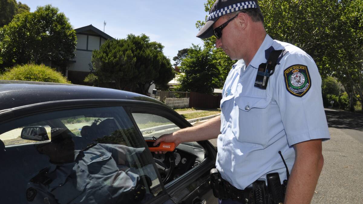 Senior Constable Ray Sheil perfoms a random drug test on a motorist yesterday morning