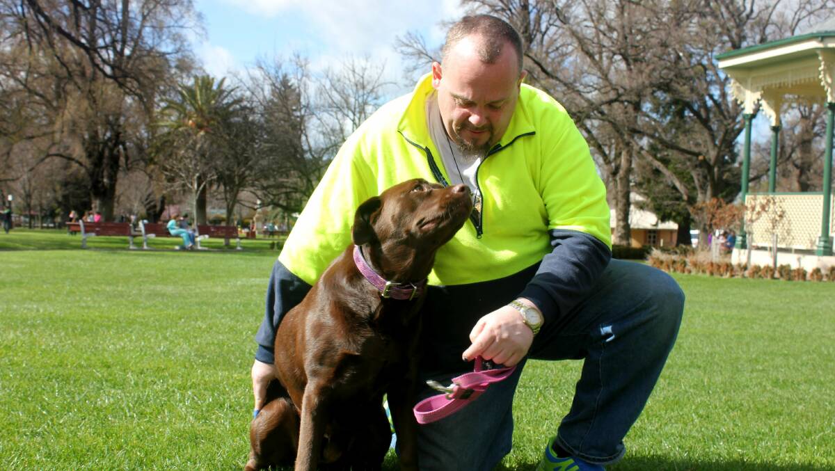 REUNITED: Local man Daniel Maybury with his American Chocolate Lab Suzie, reunited after a terrifying ordeal on Monday night thanks to cabby Paul and Coles staff member Denise. 