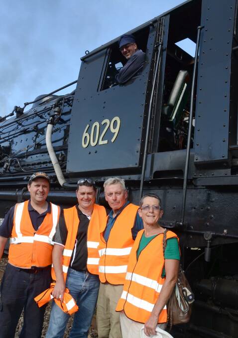 Mr and Mrs Fry (right) are pictured with Mr Gardner (left) and Mr Cooper, after stepping off the lofty footplate on Friday afternoon as driver Paul Nowlan looks on.
