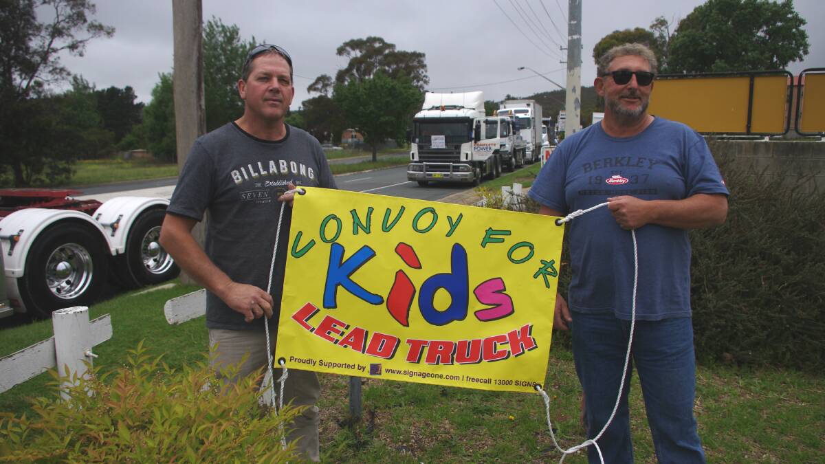 GENEROUS: Lead truck driver Jodi Charnock and Madden’s Transport owner Neil Madden with the Convoy For Kids lead-truck banner, an honor won with a $6,200 donation