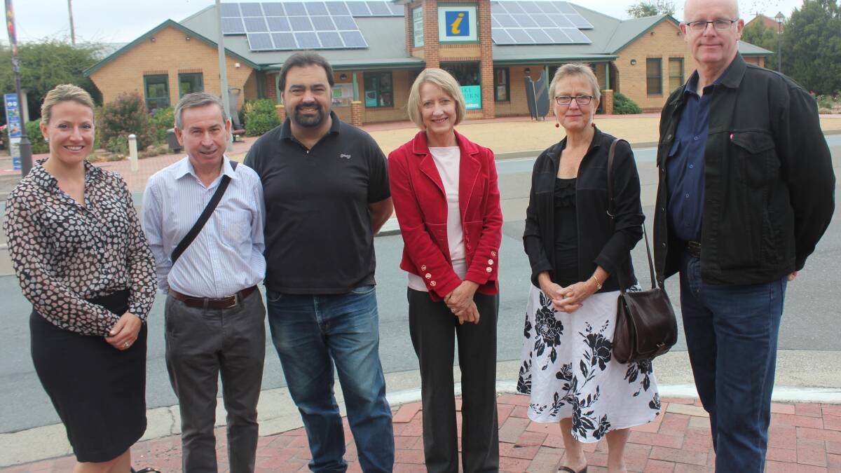 EXCITED: Goulburn Chamber of Commerce president Prue Martin (far left) joined with The Goulburn Group committee members Peter Fraser, Alex Ferrara, Mhairi Fraser, Jane Suttle and TGG president Urs Walterlin (right) in front of the solar panels on top of the Goulburn Visitor Information Centre.