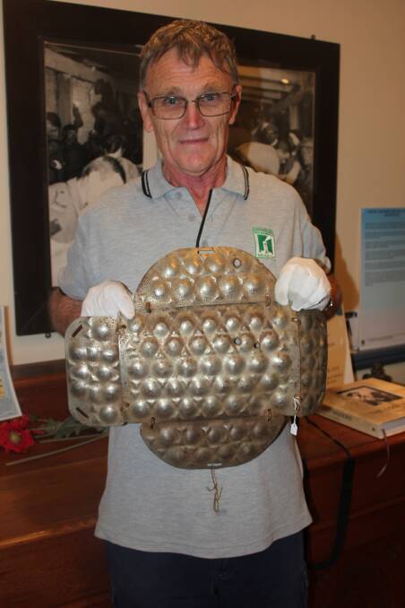 ARMOUR: Goulburn War Memorial Museum volunteer Phil Fowler with body armour used by the German Army in WWI and on display at the museum.