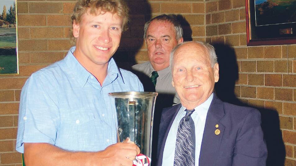 TRADITION: Ray Leeson (right) was elected patron of Goulburn Golf Club in 2005, in recognition of his 60th year as a competition player. Here he presented talented local golfer Michael Gerstenberg with his Club Championship award in 2009. 