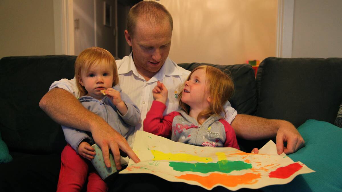 CHALLENGE: Ricky Tozer with his two girls Lyla and Ella. The Tozers are one of a number of families who have been left to find a new child care centre, following the announced closure of the TAFE facility 