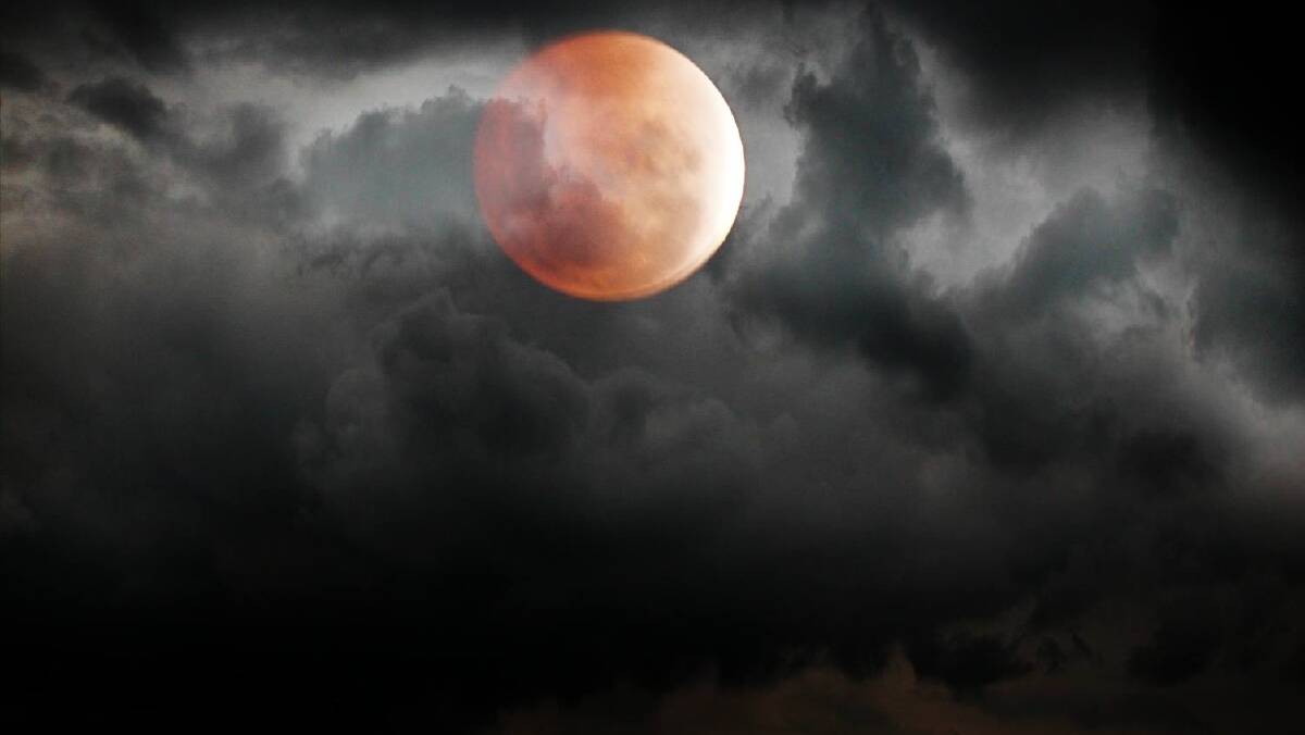 BLOOD MOON ON THE RISE: Stuart Baker caught the red moon just as it was coming out from beneath a cloud on Tuesday night in Goulburn.