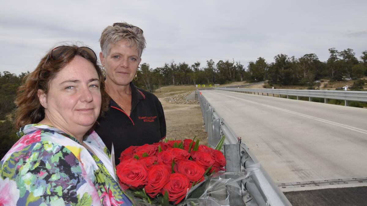 IN MEMORY: Melissa Pearce (left, with sister-in-law Sue Ellen Hughes) paid tribute to her late partner James Hughes (inset) who died in an October motorcycle accident on the approach to Oallen Ford Bridge, re-opened yesterday. Main photo: Louise Thrower