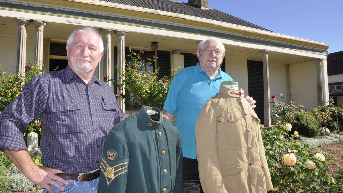 JUST GRAND: Goulburn and District Historical Society president Garry White (right) and vice-president Roger Bayley are gearing up for St Clair’s grand reopening on April 18. Here they display an Australian Horse Brigade dress uniform and a field uniform from the Boer War, which will be included in an exhibition on the day.