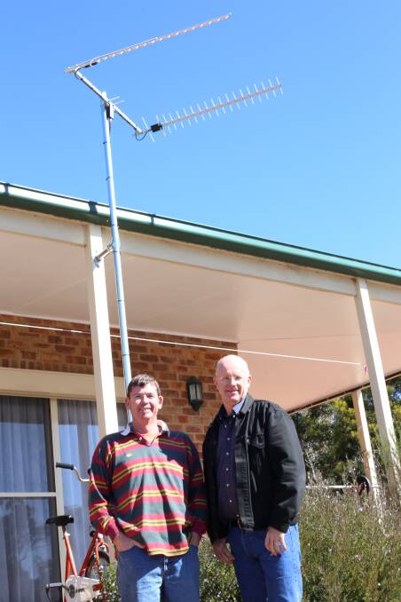 ON THE DOORSTEP: G-Spotter Antennas creator David Edworthy pictured with Kooringaroo Rd resident Urs Walterlin. Above them, the specialised equipment made by Mr Edworthy for rural users to access 4G data.