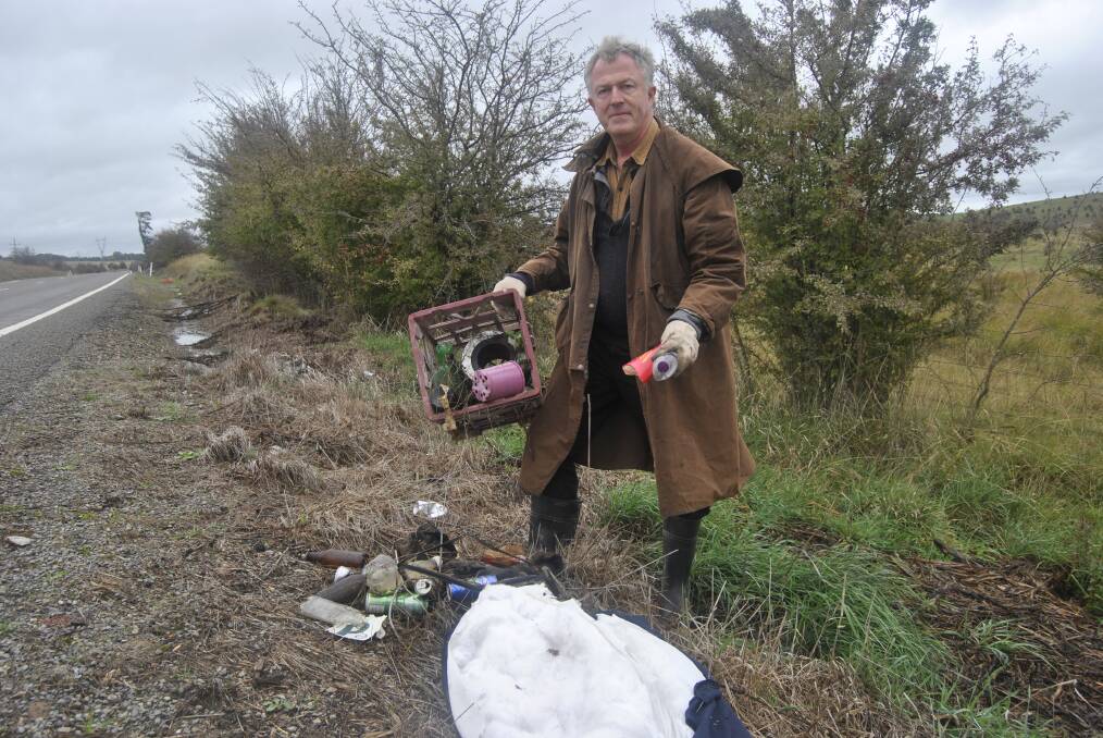 Randolph Griffiths pictured on Monday among bag loads of rubbish.