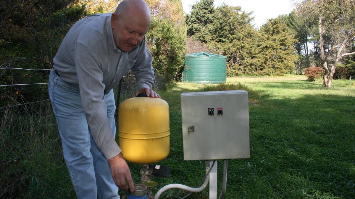 WHERE’S THE PROOF?: Gos Cory checks the meter on a pump supplying bore water irrigation on his Clyde St property. He says Council’s policy, insisting that bores have backflow devices installed to prevent contamination of the town’s water supply, is flawed logic.