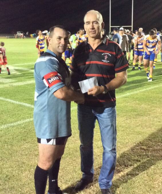 Mick Dodson being presented with the man of the match award by former Penrith Panther legend Matt Goodwin. Photo: Joe Stephens 