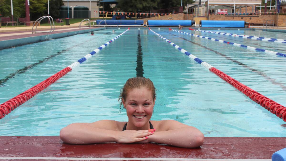 MARATHON MISSION: 23-year-old Sophie Hall stops for a breather in her 5km swim to help raise money for the ‘swimability program’ at the YMCA Swimathon at the Goulburn Aquatic Centre yesterday.
Photo: CHRIS CLARKE.