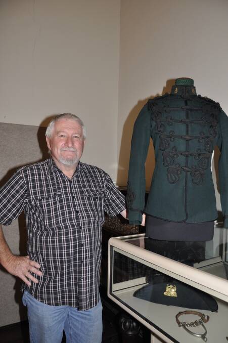 Goulburn and District Historical Society vice-president Roger Bayley shows off a restored 1897 Australian Horse Brigade uniform, which is part of the 'They Were Our Boys' exhibition. 
