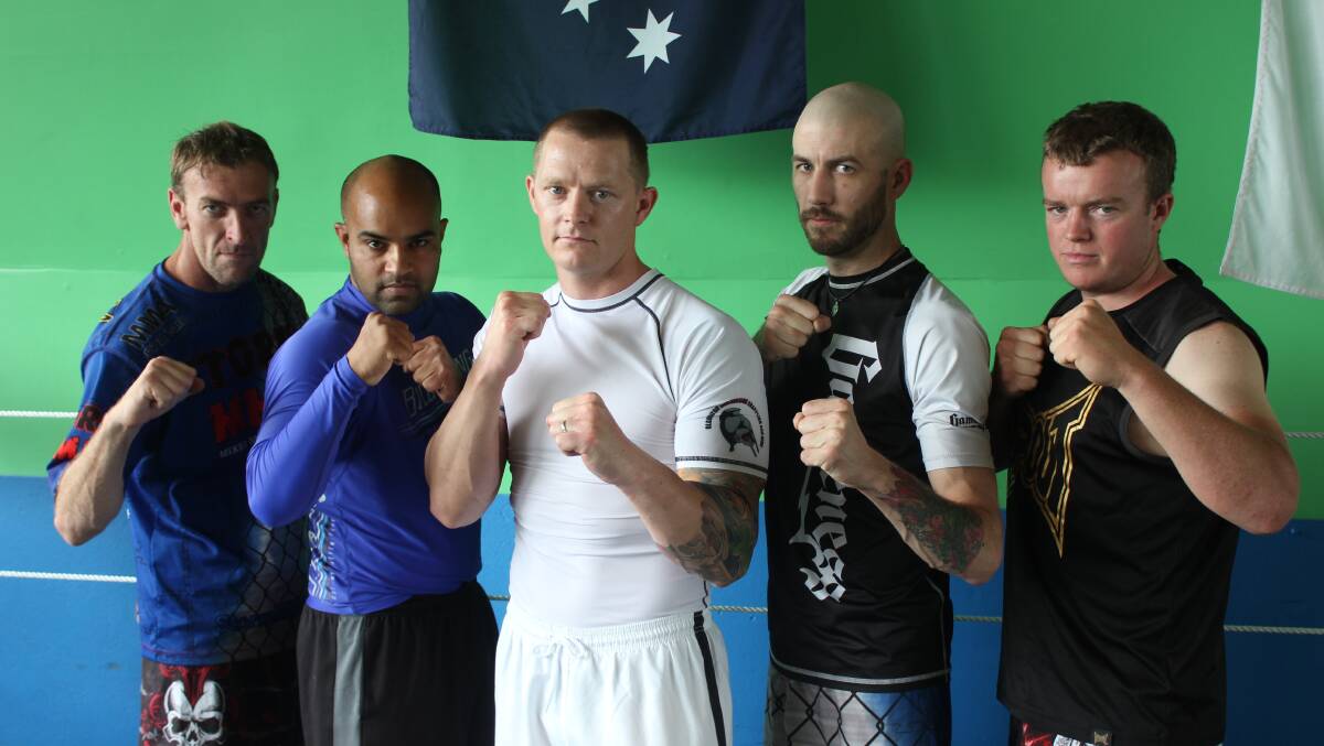 READY: Ben
Metcalf, Jimmy
Gill, trainer Craig
Harmer of the
PCYC, Ryan Green
and George Martin
are all ready for
battle ahead of
tomorrow’s Storm
Front MMA
competition at the
Workers Club.
Photo: Chris
Clarke