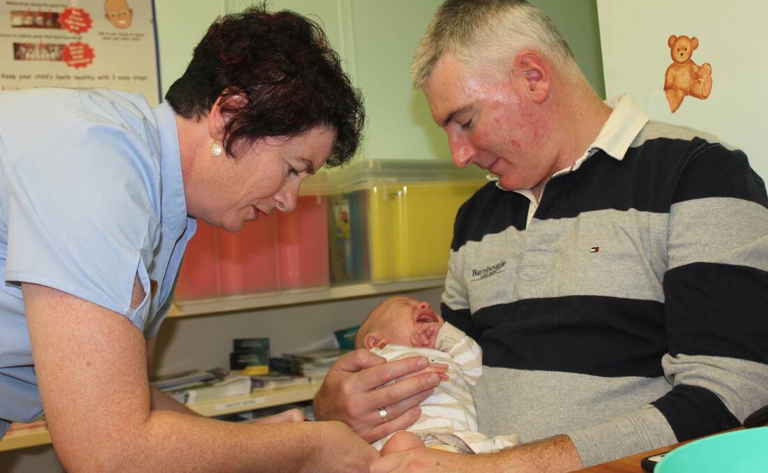 ROUTINE: Marima Medical Clinic immunisation nurse Andrea Hunter gives little baby Sebastian, (6 weeks), his routine vaccination against potentially fatal diseases whilst his dad Chris looks on.  