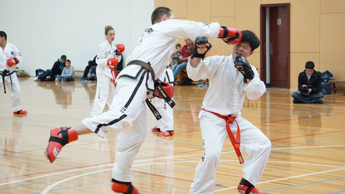 BLACK BELT: Goulburn’s Craig
Harmer spars at his 6th degree black
belt grading. He is now only one
level before reaching the title of
master.