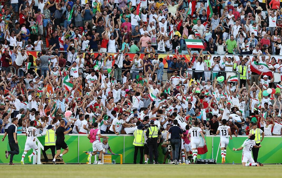 PATRIOTISM: Iranian supporters celebrate a goal in last Friday's sell out quarter final match between Iran and Iraq at Canberra Stadium. Photo: Getty Images / Stefan Postles