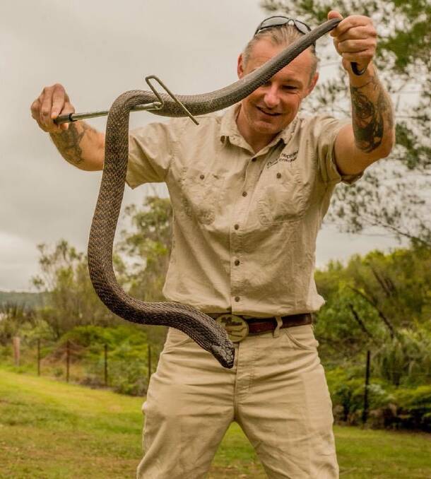 Ray McGibbon with a snake rescued from one of the properties in Goulburn. Pic: Supplied 