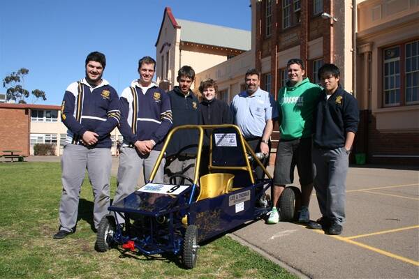 Goulburn High School students Jesse Lee, Mat Scott, Andrew Caldow, Jacob Baker and Shannon Chen (far right) and teachers Vero Joseph and Scott O’Hara standing next to the go kart they built for CAMS School Challenge, which is being held in Canberra today.