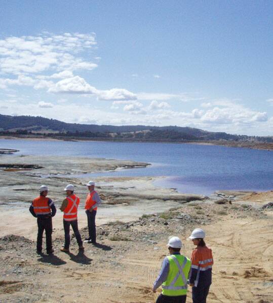 • DAM FINE: TriAusMinofficials and consultants surveying tailings dams at Woodlawn Mine from which they expect to mine 80,000 tonnes of zinc, copper and lead concentrate annually.