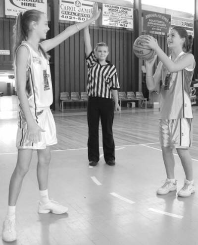 BALL'S UP: Georgia Teague and Jordan Huntley show off some of their skills at the Goulburn Basketball Stadium earlier this week. Watching on is referee Melanie Lewis.