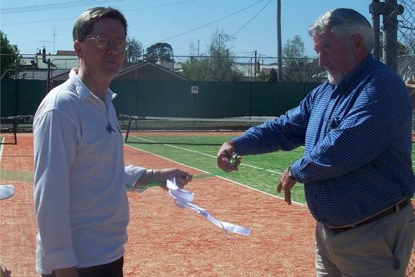 OPEN: Chairman of the Veolia Mulwaree Trust Paul Stephenson cuts a ribbon with the assistance of Richard Hailston.