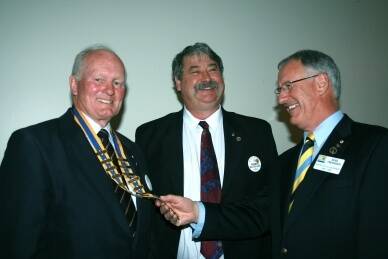 PROUD MOMENT: A past District Governor of Rotary District 9710, Noel Trevaskis (right) inducts Dr Jarvis Hayman president of the Rotary Club of Goulburn Mulwaree, assisted by outgoing president, Robert MacCulloch.