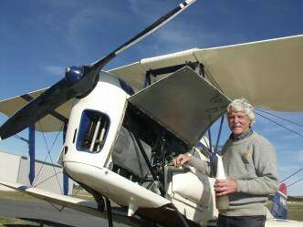 SKY THE LIMIT: Mr Nell checking his trusty DH82 Tiger Moth's engine oil at Goulburn Airport this week.