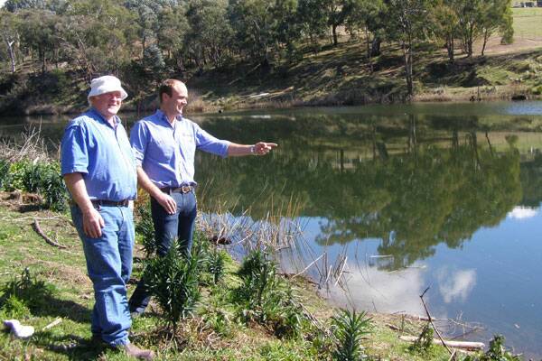 RIVER TOUR: Billyrambija Landcare group’s Ray Soper on the banks of the Wollondilly River with HNCMA’s Andrew Doran during a recent tour of the site by the HNCMA Board.