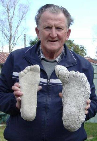 BIG FOOT: Rex Gilroy with two ‘Yowie’ footprints that he owns in his collection at his home in Katoomba. 