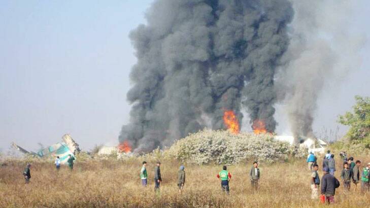 Smoke and flames rising from the scene of an Air Bagan passenger plane crash near Heho airport in Myanmar's eastern Shan state.