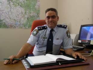 FAREWELL: Superintendent Wayne Benson sits in the Goulburn LAC Commander's chair for the final time on Wednesday. He will take up a chief superintendent's position with the State Protection Group next