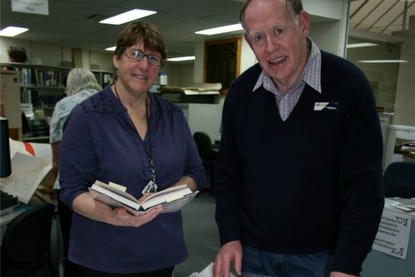 RICH HERITAGE: Regional history librarian Lynn Bonomini and author and volunteer Tom Bryant look over just some of the resources to be utilised in next month’s Australian Society of Genealogists seminar in Goulburn.