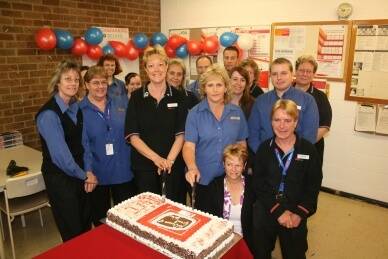 THE CREW: Original staff members Donna Squires and Leone Chambers cut Kmart’s 40th birthday cake as they celebrate along with (left) Lee-ann Shephard, Liz Giddings, Natalie Jeffery, Katrina Cochran, Jan Rose, Glynn Wood, Kyle Hogan, Linda Spencer, Kylie Chalker, Kerry Guymer, Robert Gray, Maria Poidevin and Wayne Crouch, the Kmart Team.