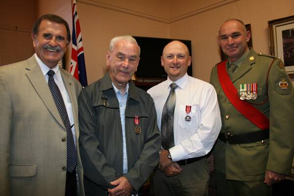 APPRECIATION: Goulburn man Brian Neve (second left) and Jason McAndrew from Tarago were presented with Defence Medals by Hume MP Alby Schultz and the Australian Army’s warrant officer (class 2) Detlef Jansen last Monday.
