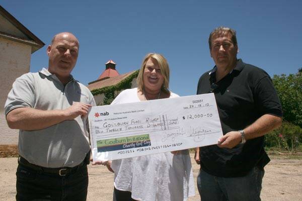 HELPING OUT: Anglicare Canberra/Goulburn CEO Simon Bennett (left) and his assistant Allison Clack accepted a $12,000 cheque before Christmas from co-organiser of last year’s charity golf day, Steve Jones.
