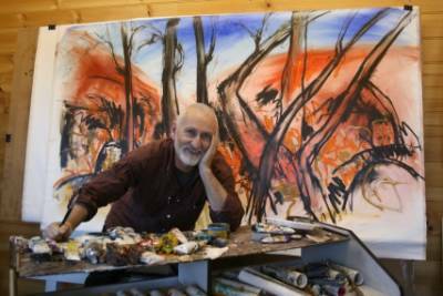 SATISFACTION: Goulburn artist Bob Millis in his studio after putting the finishing touches on one of his Ruby Gap paintings that depicts gnarled ghost gums in a dry creek bed.